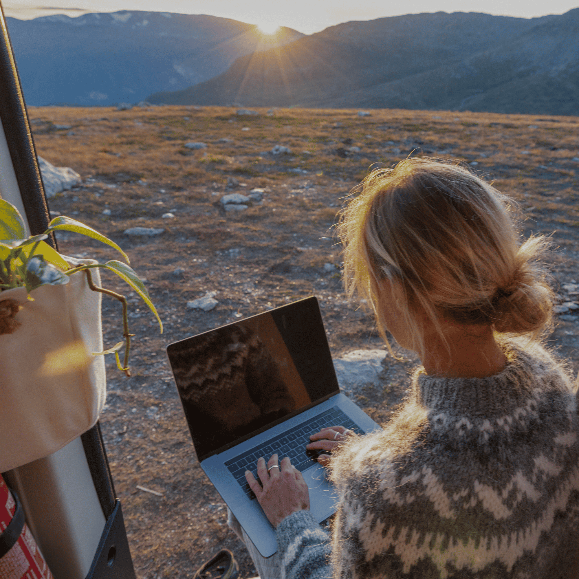 Person working on a laptop outdoors, representing embedded insurance available anytime, anywhere